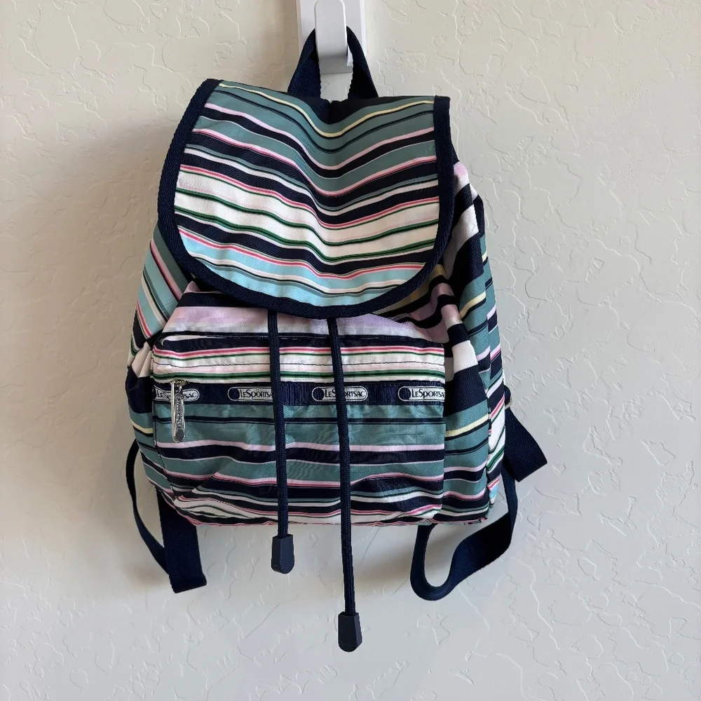 LeSportsac Voyager drawstring backpack in a navy pastel stripe pattern.